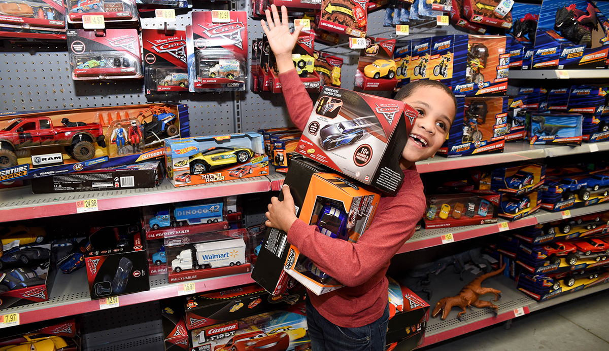 Young boy picking out toys during Voices for Children Holiday Drive